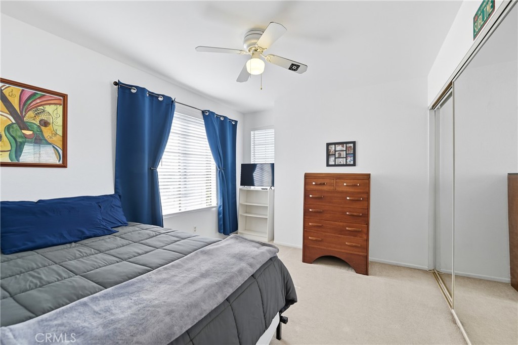 21902-21902 Raintree Lane Lake Forest, CA 92630 - Photo 18 of 46 a bedroom with a bed and a chandelier