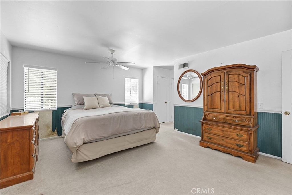 21902-21902 Raintree Lane Lake Forest, CA 92630 - Photo 20 of 46 a bedroom with a bed a closet and a dresser