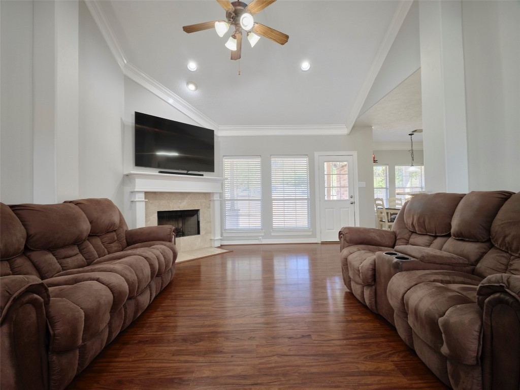 9315 Anna Street Needville, TX 77461 - Photo 12 of 46 a living room with furniture a flat screen tv and a fireplace