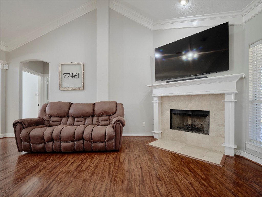 9315 Anna Street Needville, TX 77461 - Photo 15 of 46 a living room with furniture a flat screen tv and a fireplace