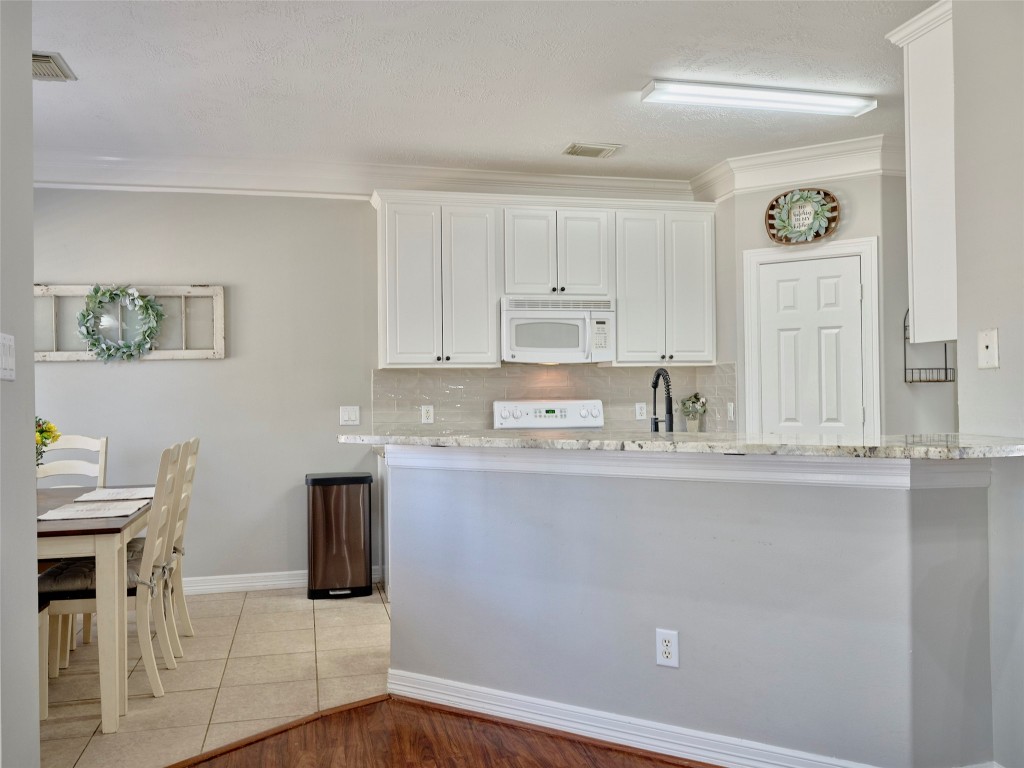 9315 Anna Street Needville, TX 77461 - Photo 16 of 46 a kitchen with stainless steel appliances granite countertop a sink and cabinets