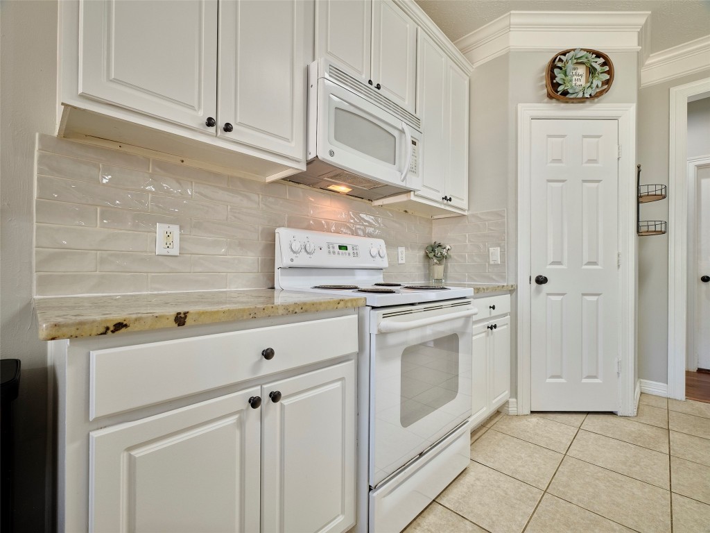 9315 Anna Street Needville, TX 77461 - Photo 19 of 46 a kitchen with white cabinets and white appliances