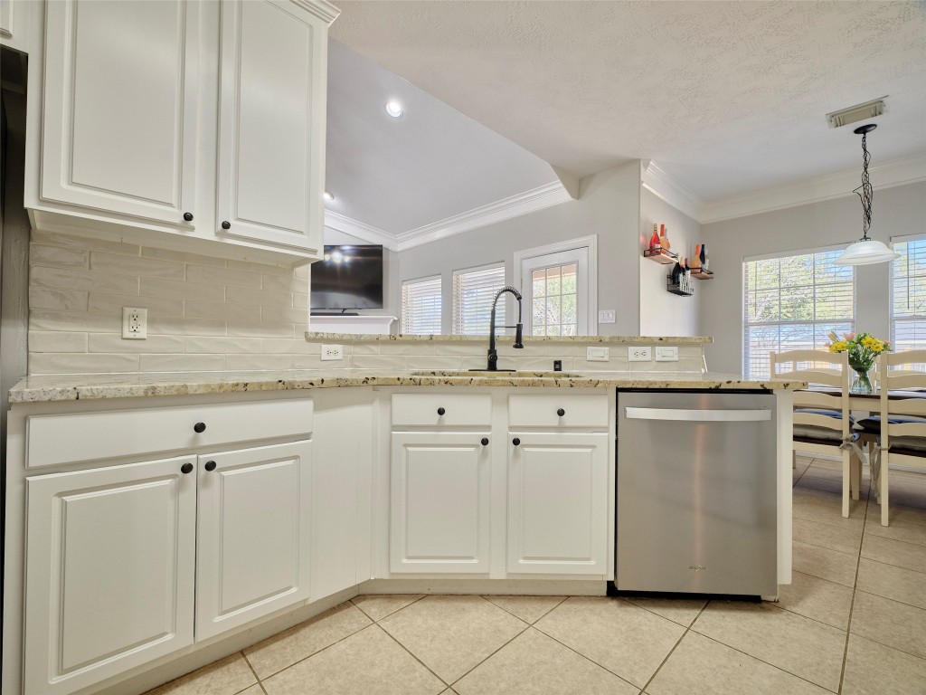 9315 Anna Street Needville, TX 77461 - Photo 20 of 46 a kitchen with granite countertop white cabinets and white appliances