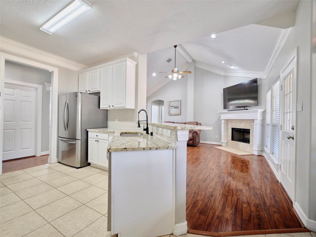 9315 Anna Street Needville, TX 77461 - Photo 24 of 46 a kitchen with stainless steel appliances kitchen island granite countertop a refrigerator and a stove top oven