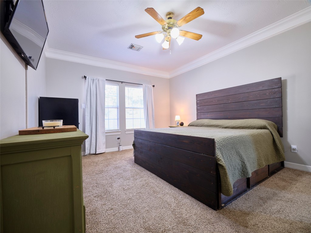 9315 Anna Street Needville, TX 77461 - Photo 25 of 46 a bedroom with a bed and a flat screen tv