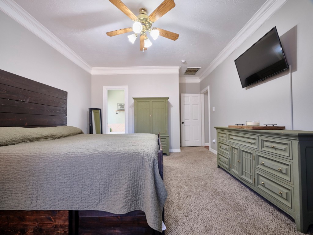 9315 Anna Street Needville, TX 77461 - Photo 26 of 46 a bedroom with a bed and a flat screen tv
