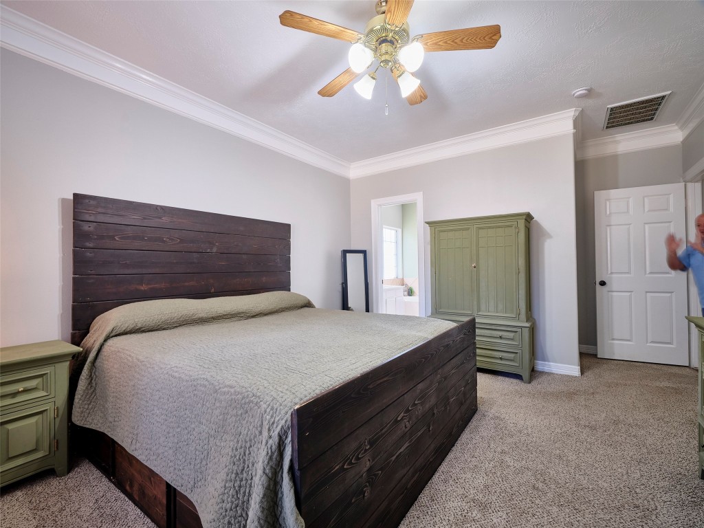 9315 Anna Street Needville, TX 77461 - Photo 27 of 46 a bedroom with a bed and a chandelier