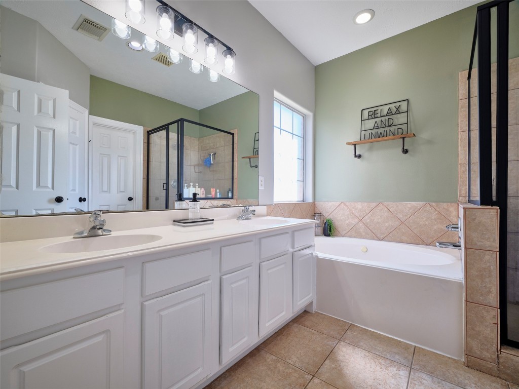 9315 Anna Street Needville, TX 77461 - Photo 28 of 46 a bathroom with a sink a large mirror and a bathtub
