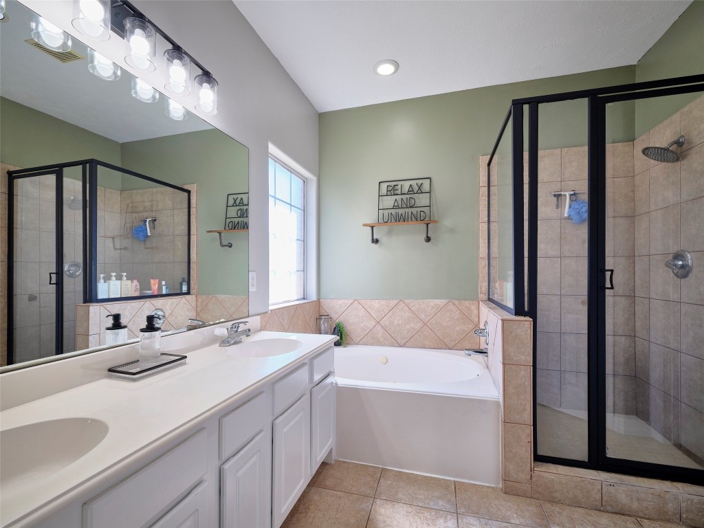 9315 Anna Street Needville, TX 77461 - Photo 29 of 46 a bathroom with a granite countertop sink mirror and shower