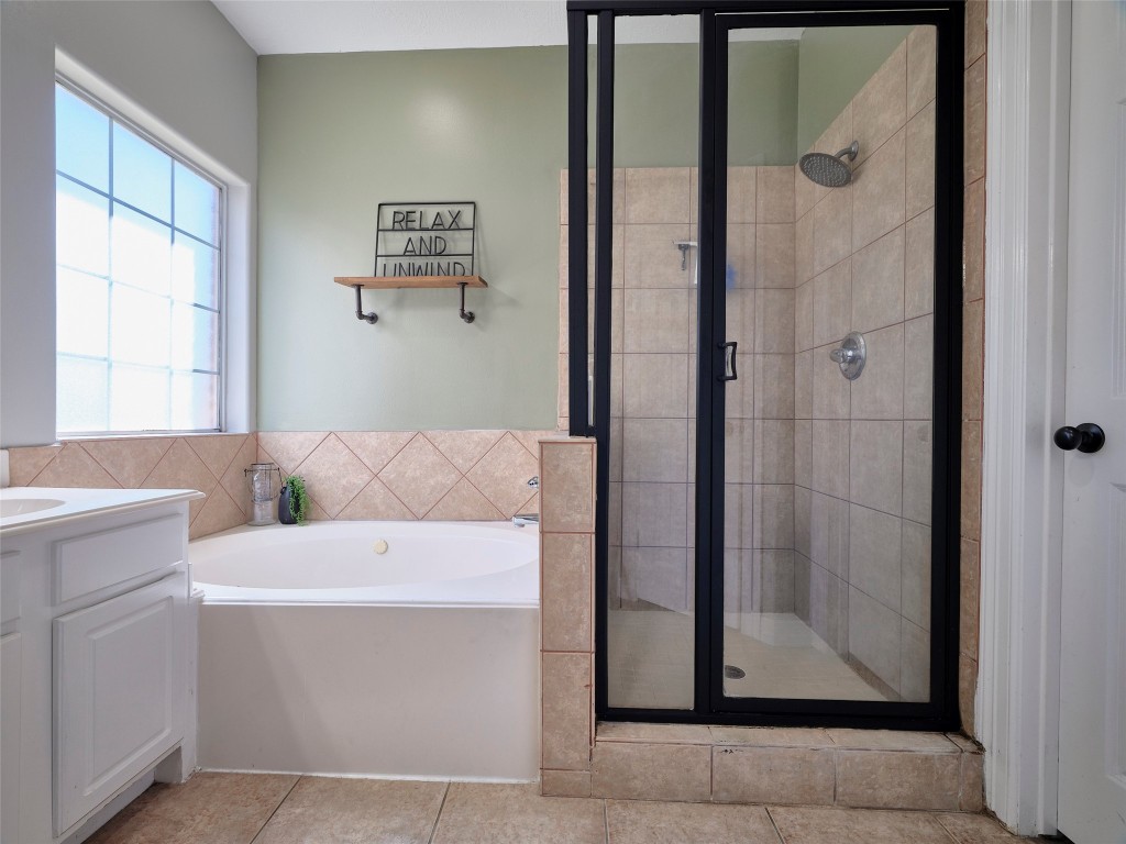 9315 Anna Street Needville, TX 77461 - Photo 30 of 46 a bathroom with a bathtub and a shower