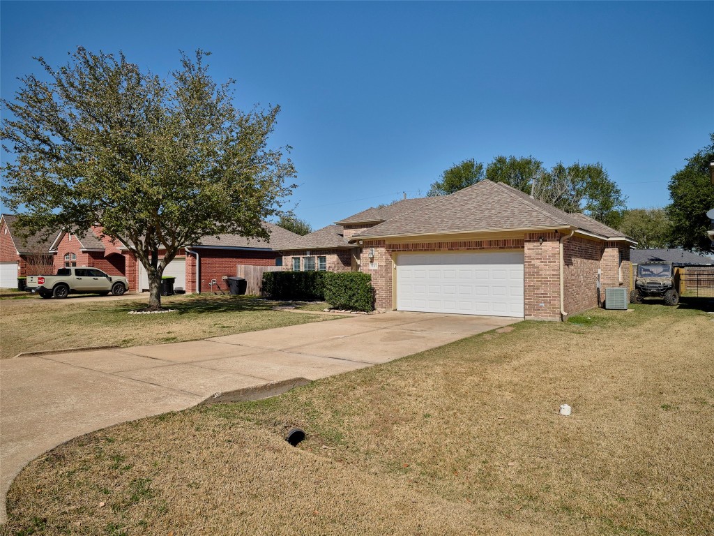 9315 Anna Street Needville, TX 77461 - Photo 3 of 46 a front view of a house with a yard and garage