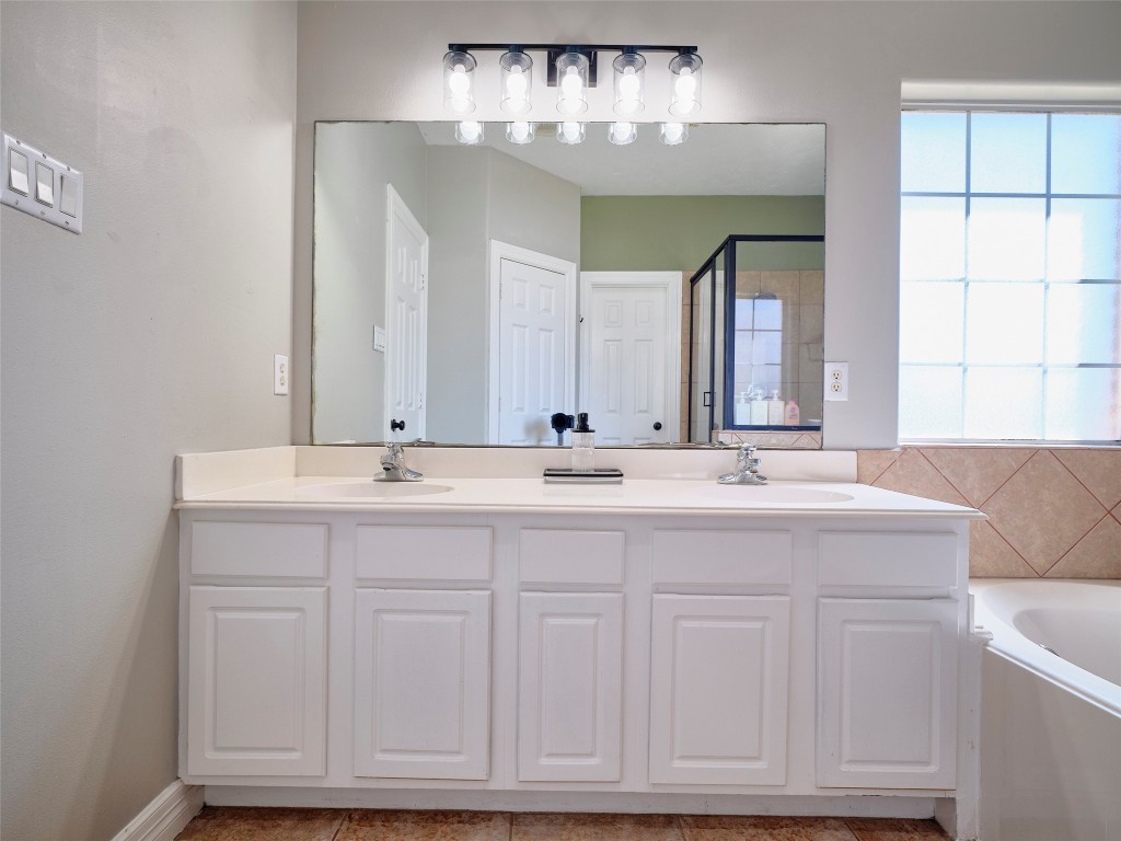 9315 Anna Street Needville, TX 77461 - Photo 31 of 46 a bathroom with double vanity and a mirror