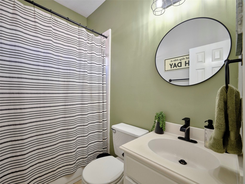 9315 Anna Street Needville, TX 77461 - Photo 35 of 46 a bathroom with a toilet a sink and mirror