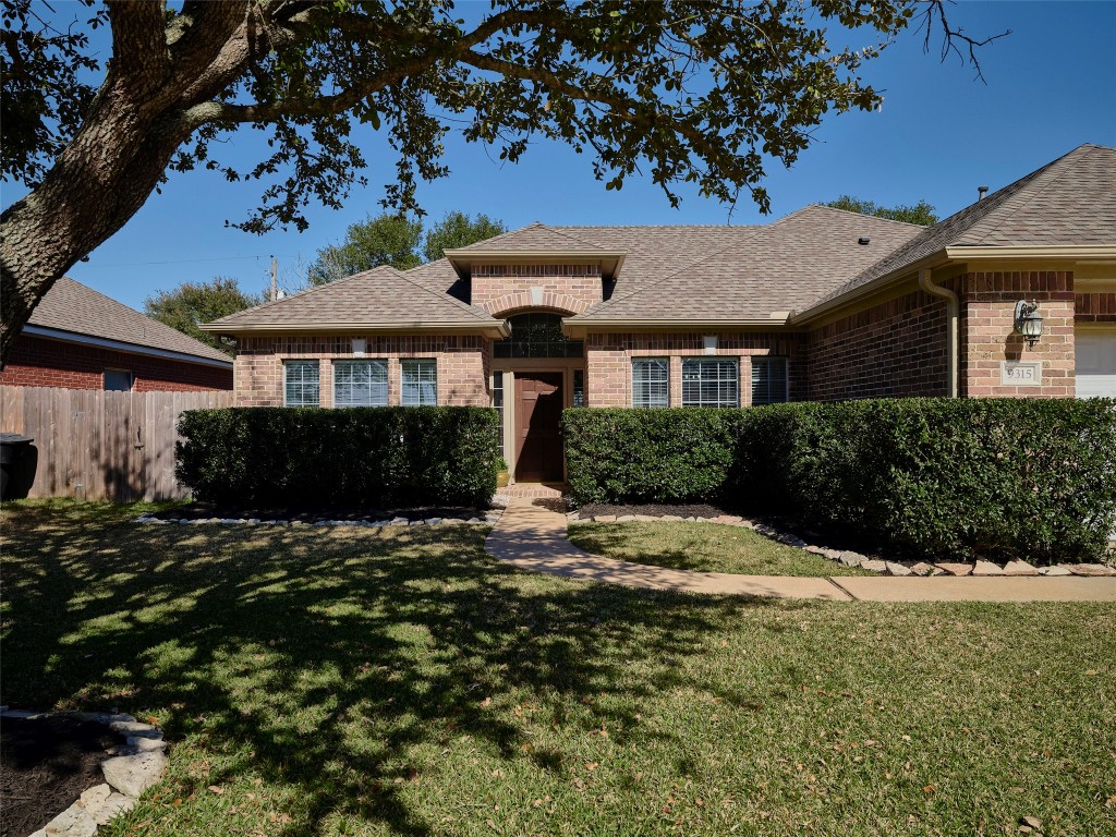 9315 Anna Street Needville, TX 77461 - Photo 6 of 46 a front view of a house with a garden