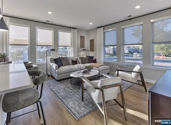 a living room with furniture and large windows
