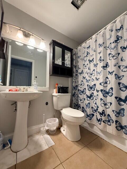 4904 Myrtle Drive Fort Pierce, FL 34982 - Photo 12 of 18 a bathroom with a toilet sink and mirror