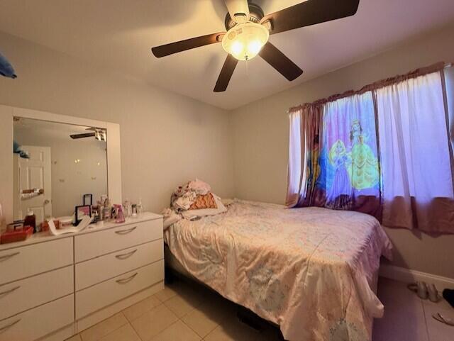 4904 Myrtle Drive Fort Pierce, FL 34982 - Photo 13 of 18 a bedroom with a bed and a chandelier