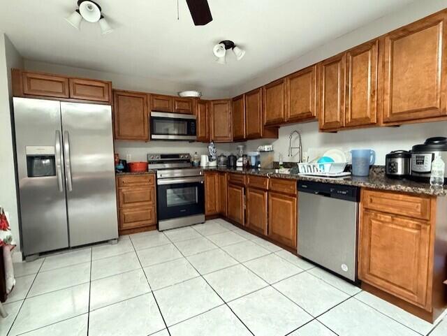 4904 Myrtle Drive Fort Pierce, FL 34982 - Photo 7 of 18 a kitchen with stainless steel appliances granite countertop a stove top oven a refrigerator a sink and dishwasher
