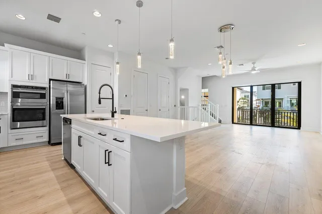 a large kitchen with stainless steel appliances granite countertop a large center island and a sink