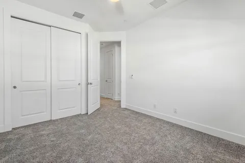 an empty room with closet area