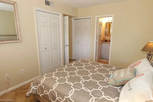 a bedroom with a bed and a mirror