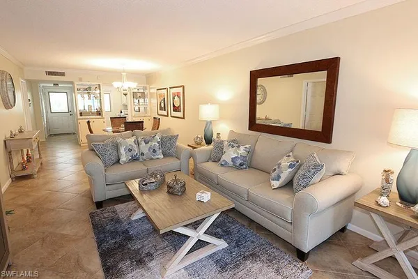 a living room with furniture and a painting