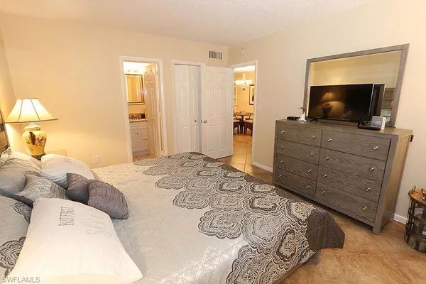 a bedroom with a bed and a television