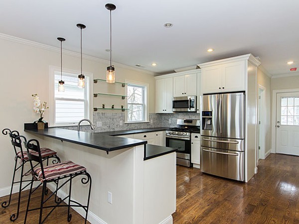 a kitchen with kitchen island a large counter top space appliances and cabinets