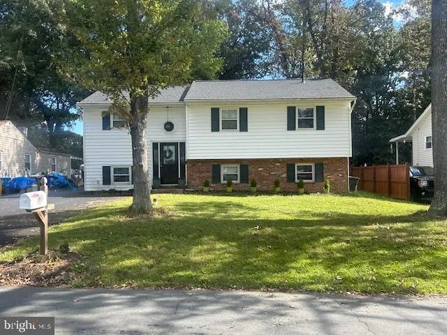a view of a house with a yard patio and swimming pool