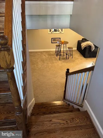 a view of water heater room with wooden floor
