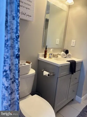 a white toilet sitting next to a bathroom sink