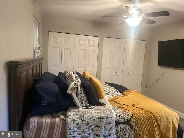 a bed sitting in a bedroom and tv