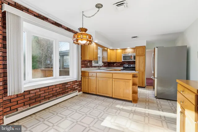 a kitchen with a refrigerator a stove and a sink