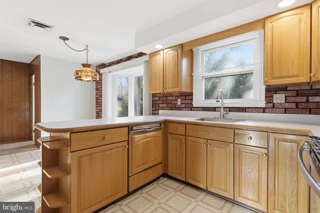 a bathroom with a sink mirror and a window