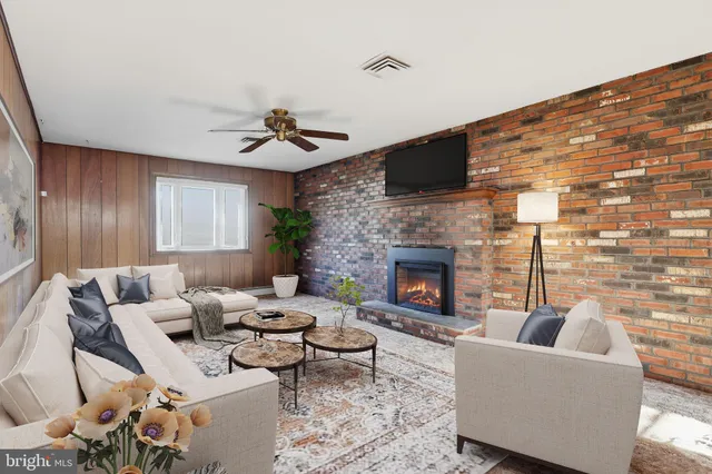 a living room with furniture and a fireplace