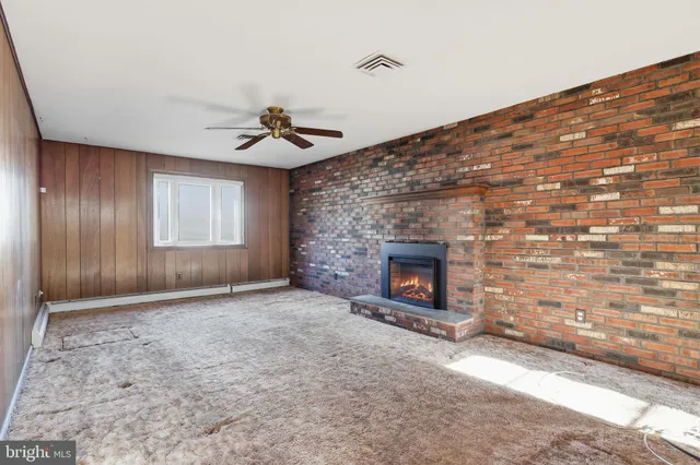 a view of an empty room with a fireplace