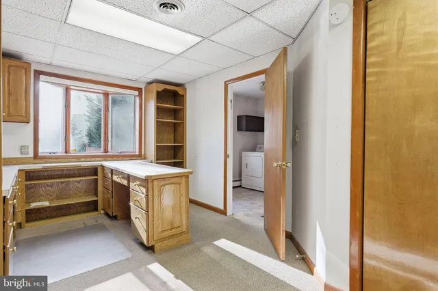 a view of a bathroom with tub and door