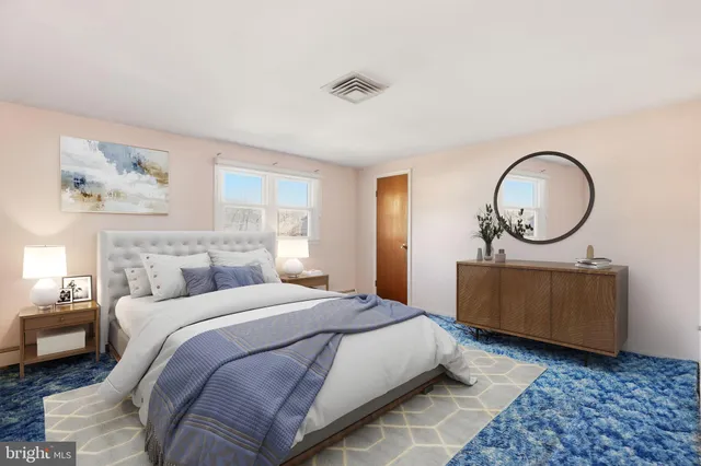 a bedroom with a bed a mirror and a window