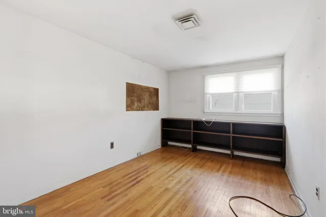 a view of a room with wooden floor and windows