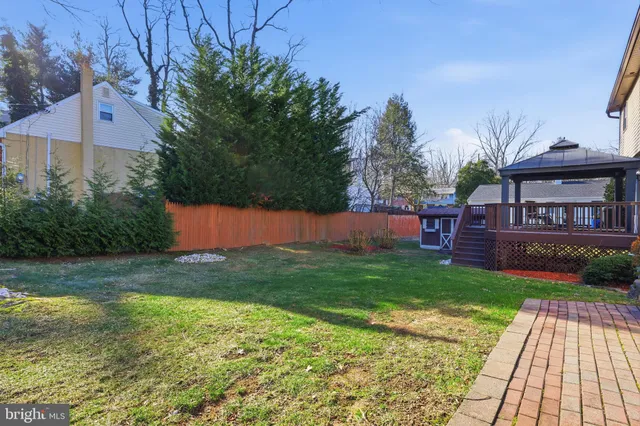 a view of backyard with outdoor seating and green space