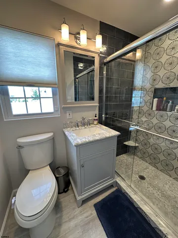 a bathroom with a sink toilet and shower