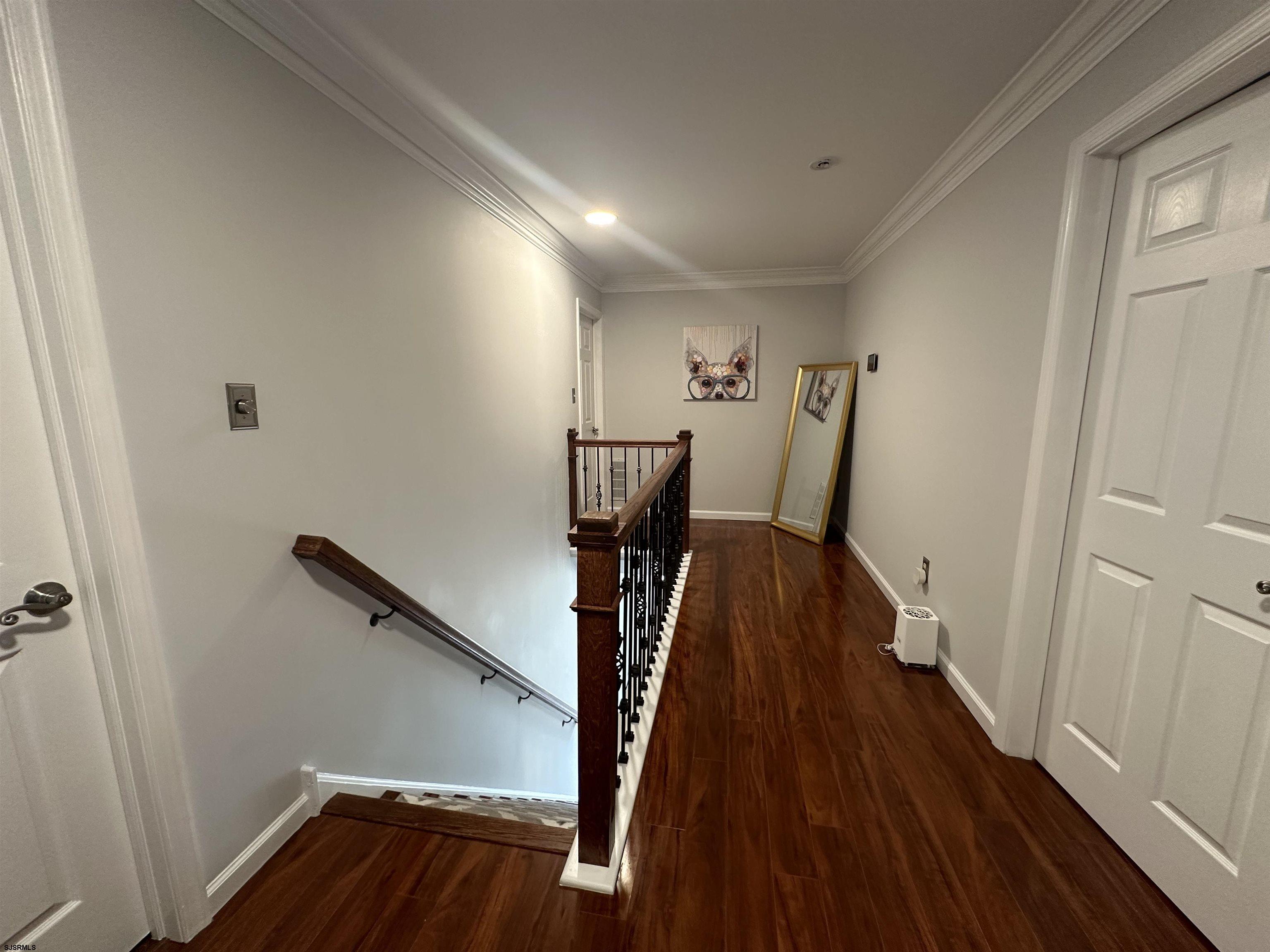 5701 Ventnor Avenue, Unit 5/217/31 Ventnor City, NJ 08406 - Photo 18 of 44 a view of a hallway with wooden floor and stairs