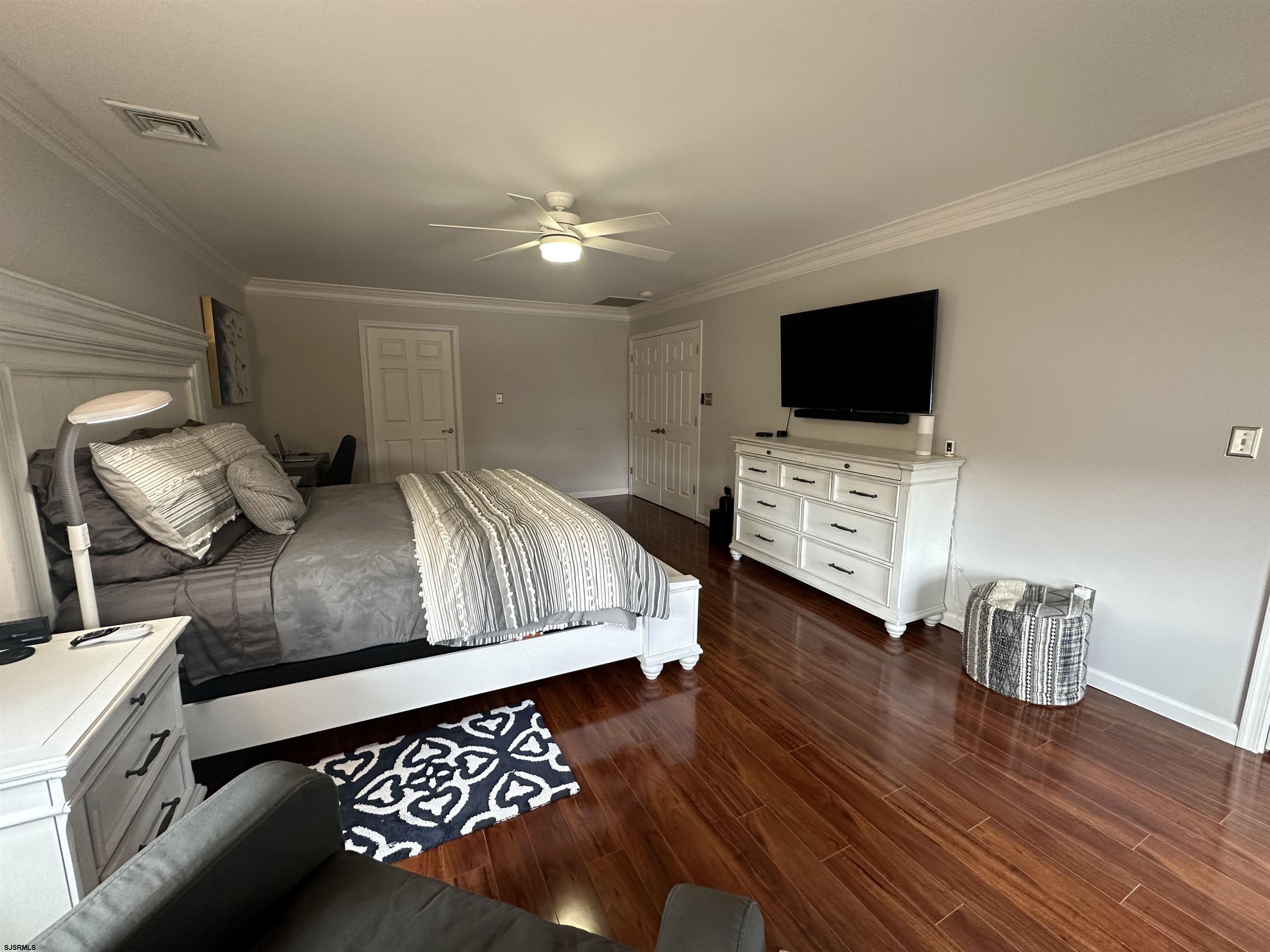 5701 Ventnor Avenue, Unit 5/217/31 Ventnor City, NJ 08406 - Photo 21 of 44 a bedroom with a bed and a flat screen tv