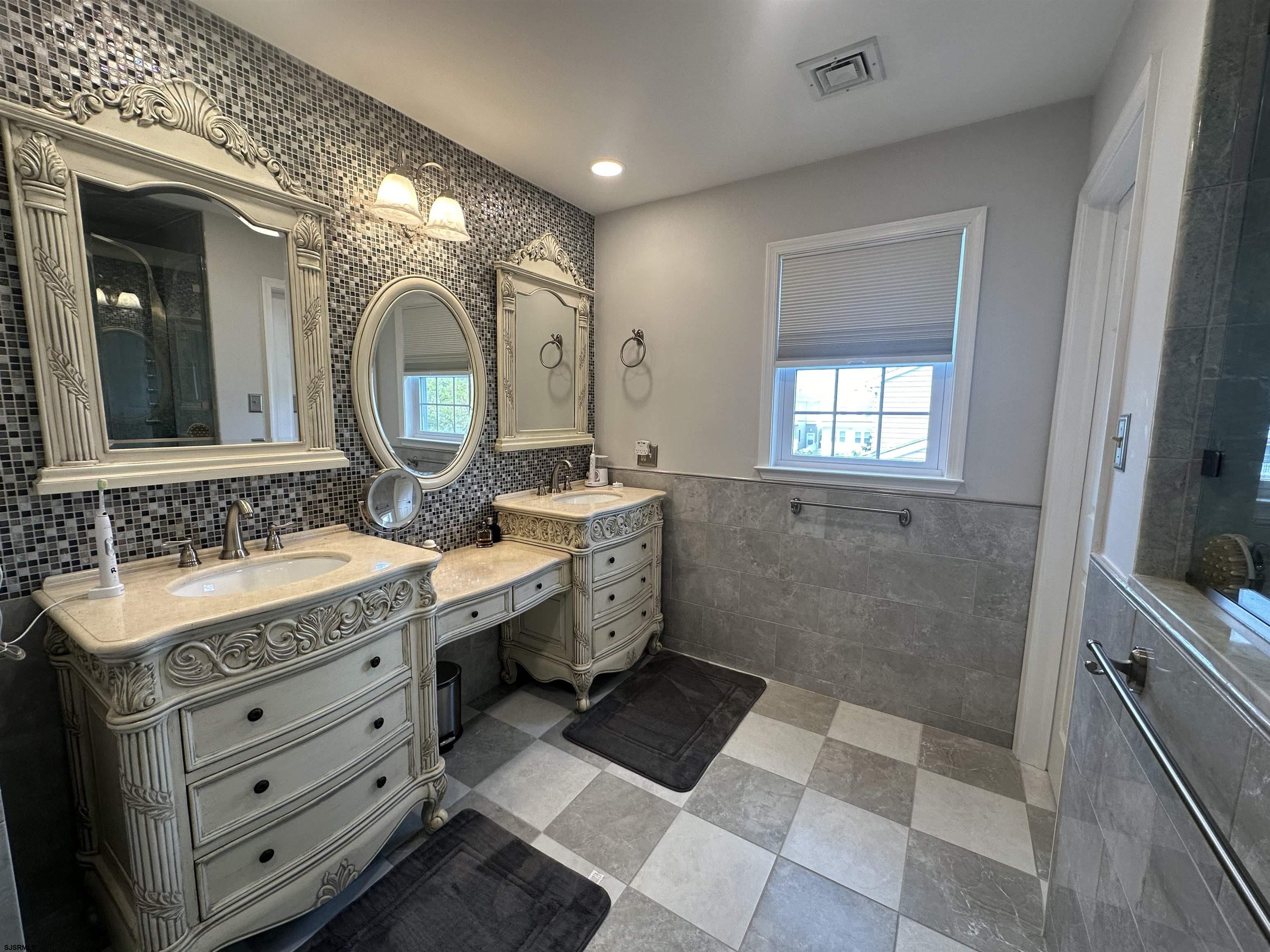 5701 Ventnor Avenue, Unit 5/217/31 Ventnor City, NJ 08406 - Photo 23 of 44 a spacious bathroom with a double vanity sink a mirror and a shower
