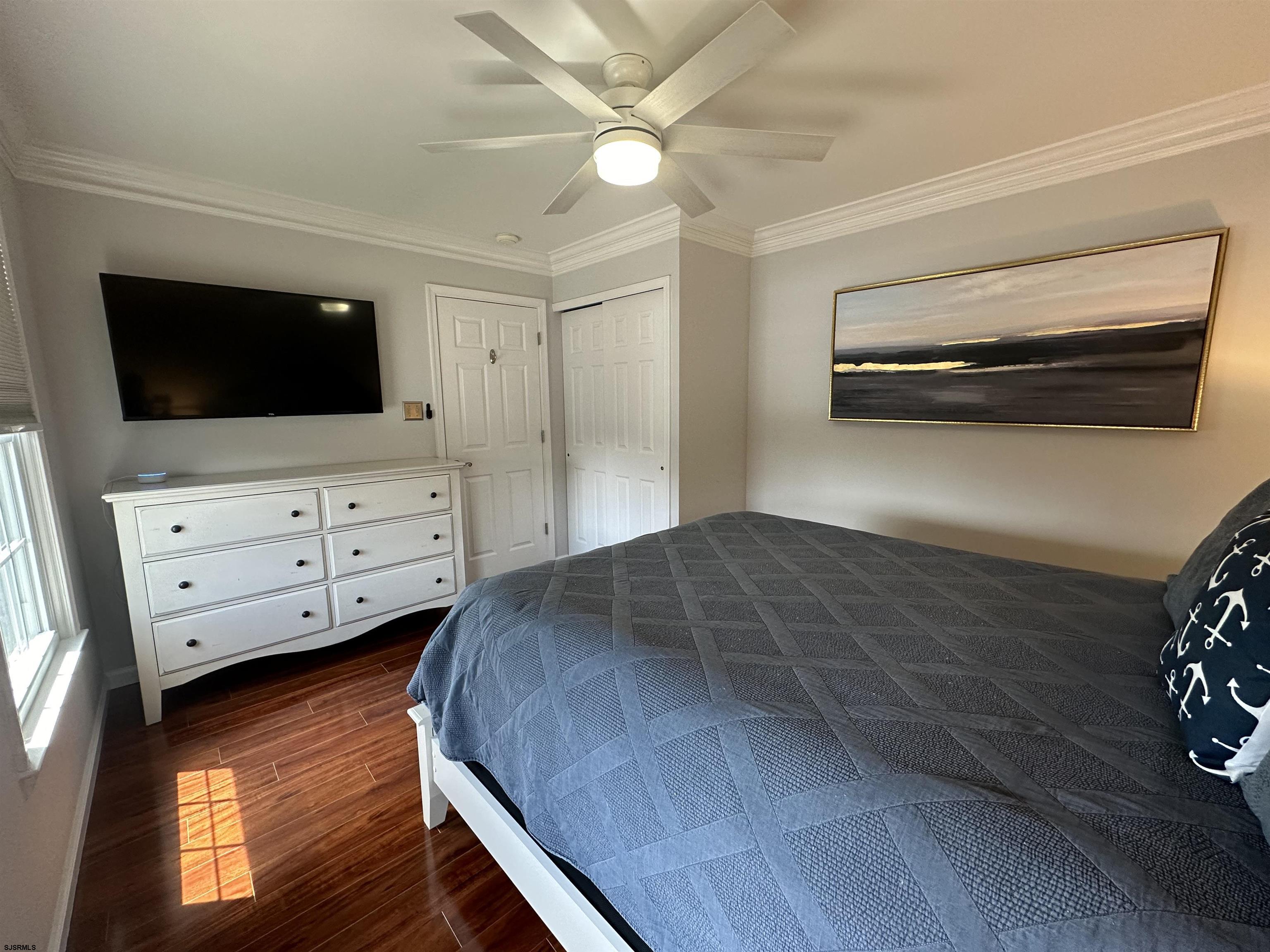 5701 Ventnor Avenue, Unit 5/217/31 Ventnor City, NJ 08406 - Photo 27 of 44 a bedroom with a bed and flat screen tv