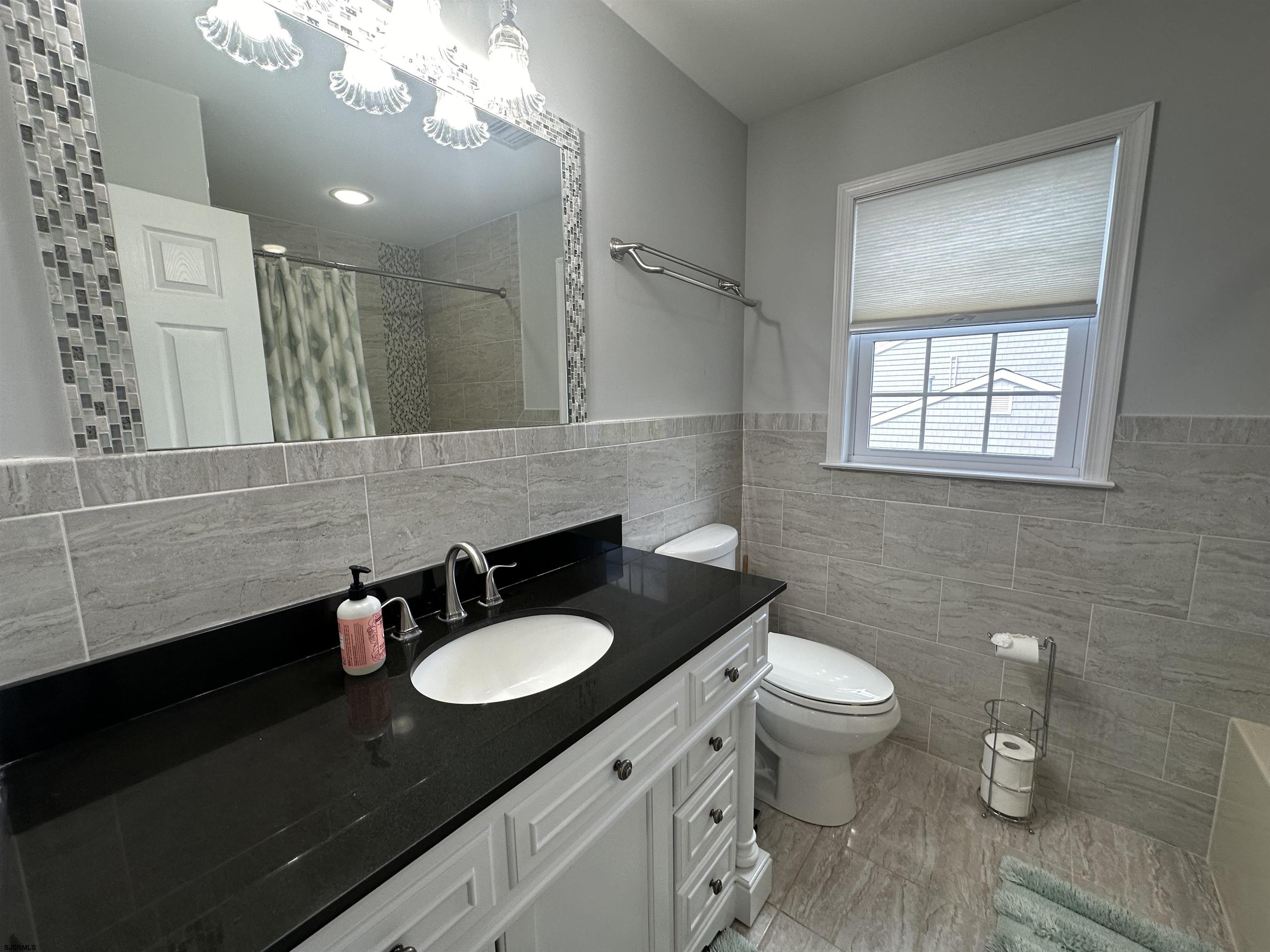 5701 Ventnor Avenue, Unit 5/217/31 Ventnor City, NJ 08406 - Photo 29 of 44 a bathroom with a sink and a mirror