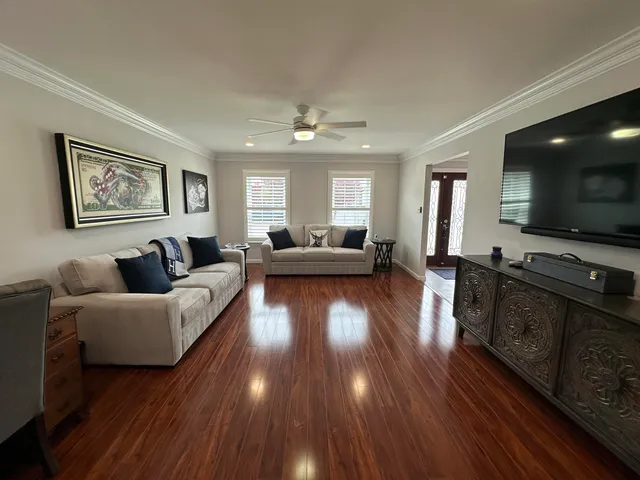 a living room with furniture and a flat screen tv