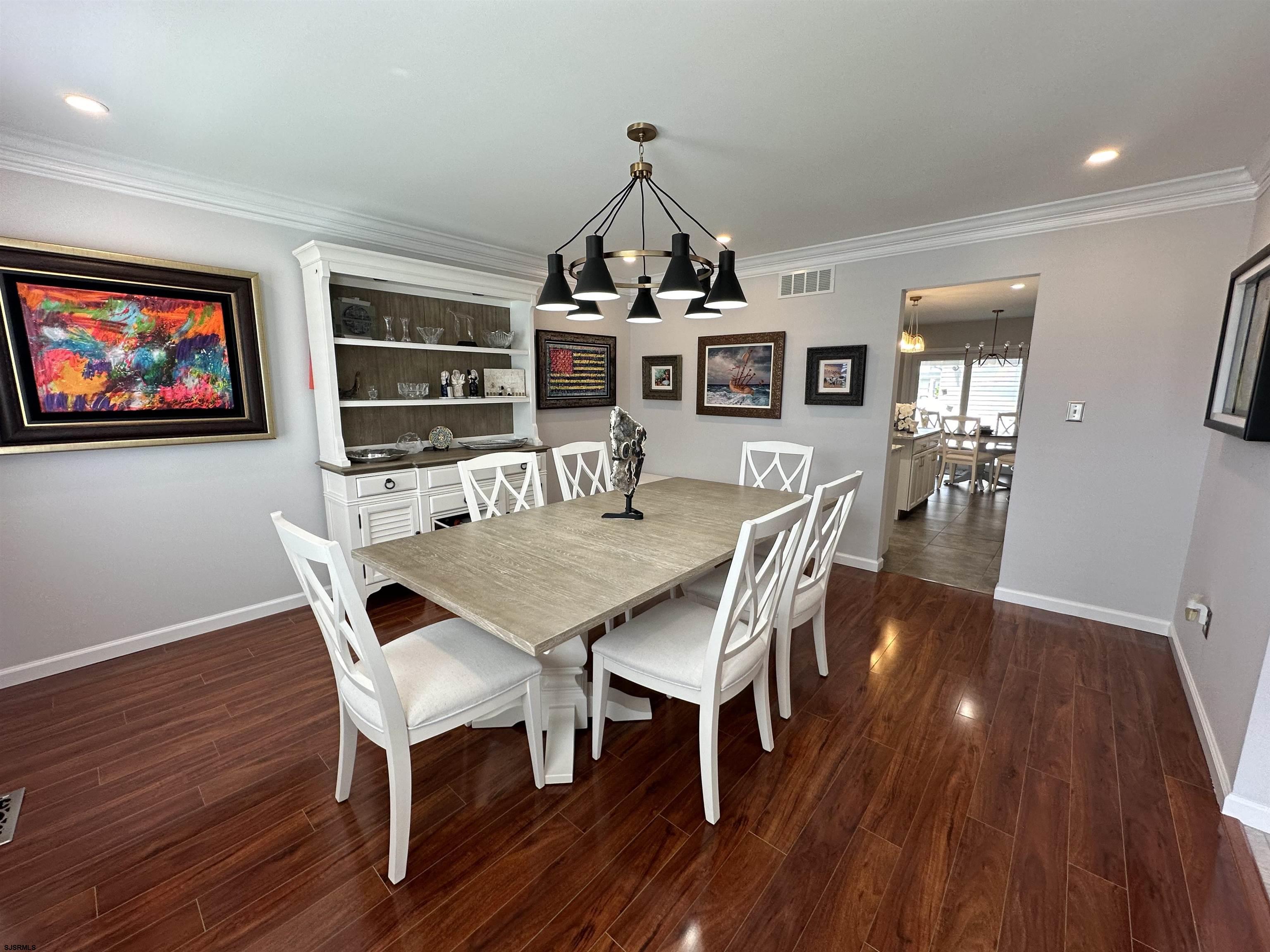 5701 Ventnor Avenue, Unit 5/217/31 Ventnor City, NJ 08406 - Photo 9 of 44 a view of a dining room with furniture wooden floor and chandelier