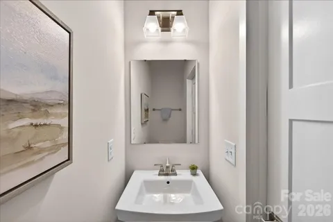 a bathroom with a sink mirror and vanity