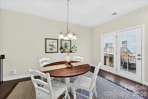 a view of a dining room with furniture and chandelier